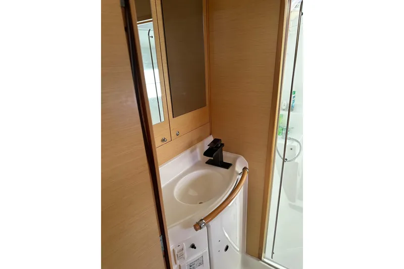 Alice Yacht Photos Pics Compact bathroom in 2015 Lagoon 380 S2 yacht with modern sink and mirror.