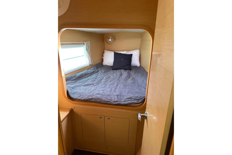 Alice Yacht Photos Pics Cozy cabin interior of 2015 Lagoon 380 S2 catamaran with bed and window.