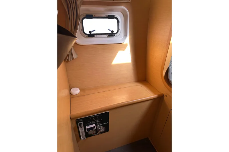 Alice Yacht Photos Pics Interior of 2015 Lagoon 380 S2 yacht with wooden paneling and small window.