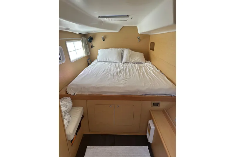 Alice Yacht Photos Pics Cozy cabin interior of 2015 Lagoon 380 S2 catamaran with comfortable bed and natural light.