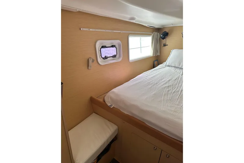 Alice Yacht Photos Pics Interior cabin of 2015 Lagoon 380 S2 catamaran with bed and porthole window.