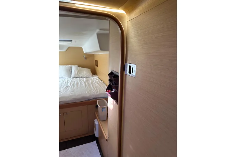 Alice Yacht Photos Pics Cozy cabin interior of 2015 Lagoon 380 S2 catamaran with wooden finish and comfortable bed.