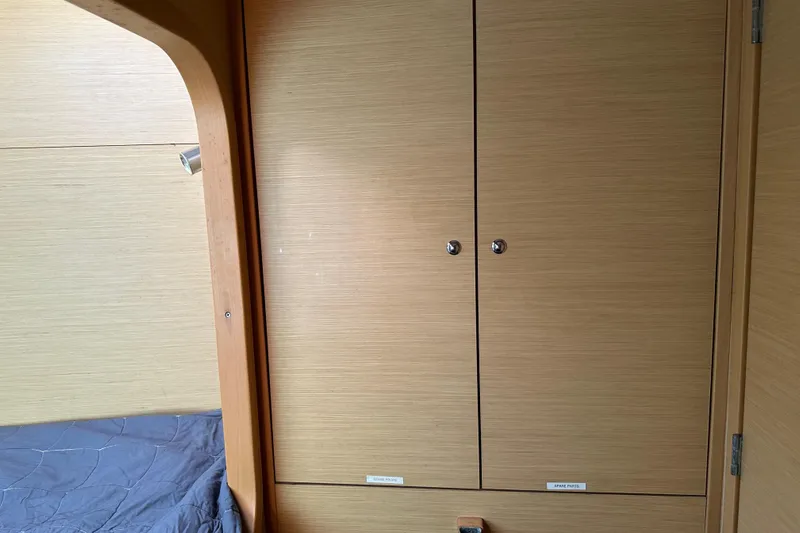 Alice Yacht Photos Pics Interior of 2015 Lagoon 380 S2 yacht with wooden cabinets and bed.