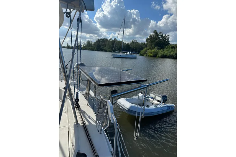 Alice Yacht Photos Pics 2015 Lagoon 380 S2 catamaran with solar panel and dinghy on calm water.