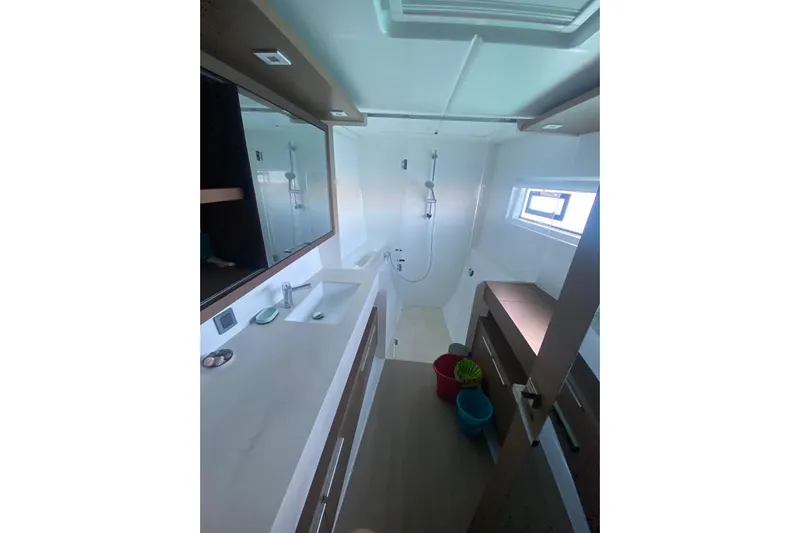  Yacht Photos Pics Modern bathroom interior of 2021 Lagoon 46 yacht with shower and sink.
