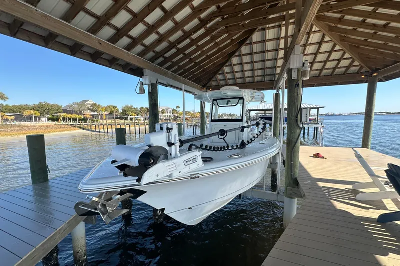  Yacht Photos Pics 2024 Sea Hunt Gamefish 30 Forward Seating boat docked under a wooden canopy.