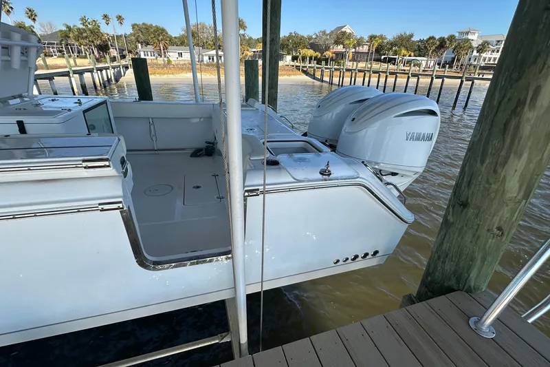  Yacht Photos Pics 2024 Sea Hunt Gamefish 30 boat with Yamaha engines docked by the water.