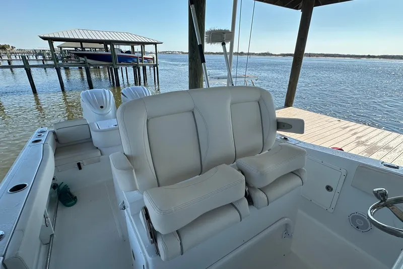  Yacht Photos Pics 2024 Sea Hunt Gamefish 30 boat with forward seating, docked by the water.