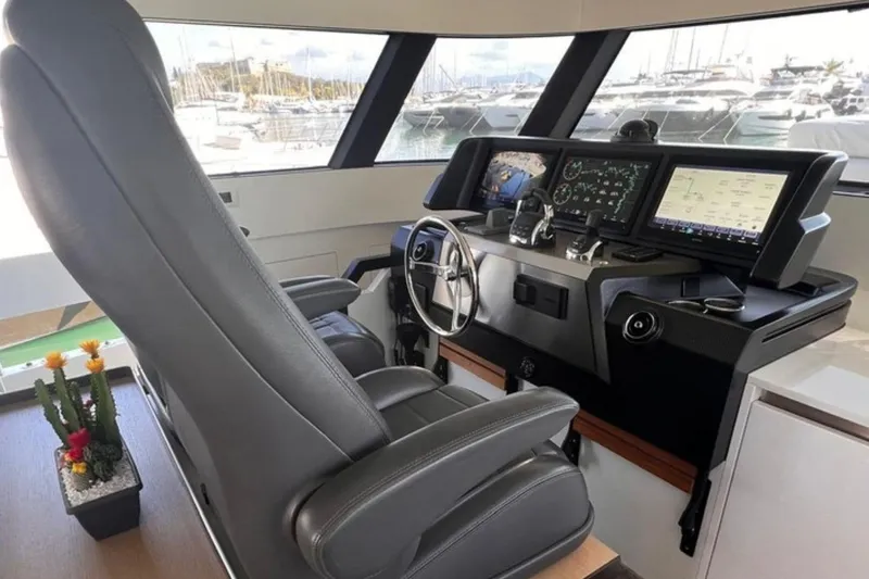  Yacht Photos Pics Pilot seat and control panel of 2020 Bluegame BGX 70 yacht, featuring modern navigation displays.