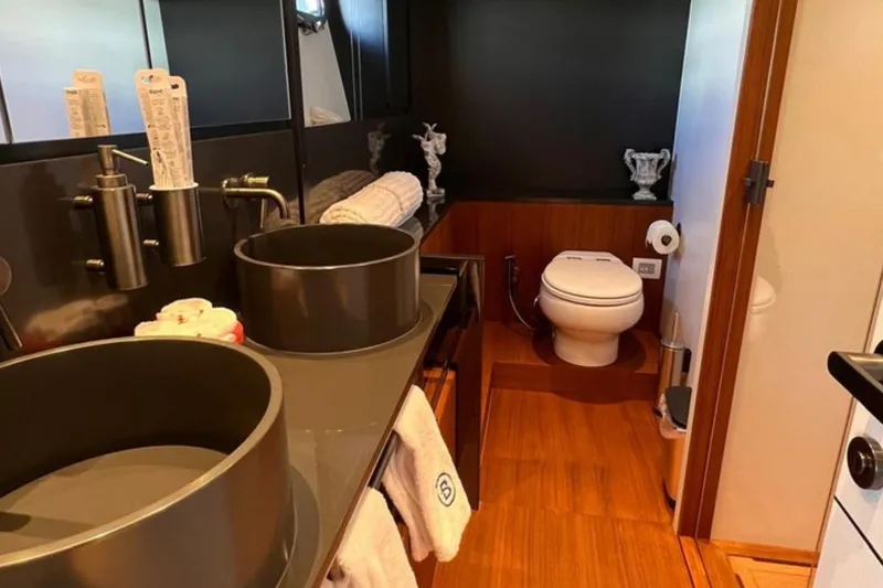  Yacht Photos Pics Luxurious bathroom interior of 2020 Bluegame BGX 70 yacht with modern fixtures.