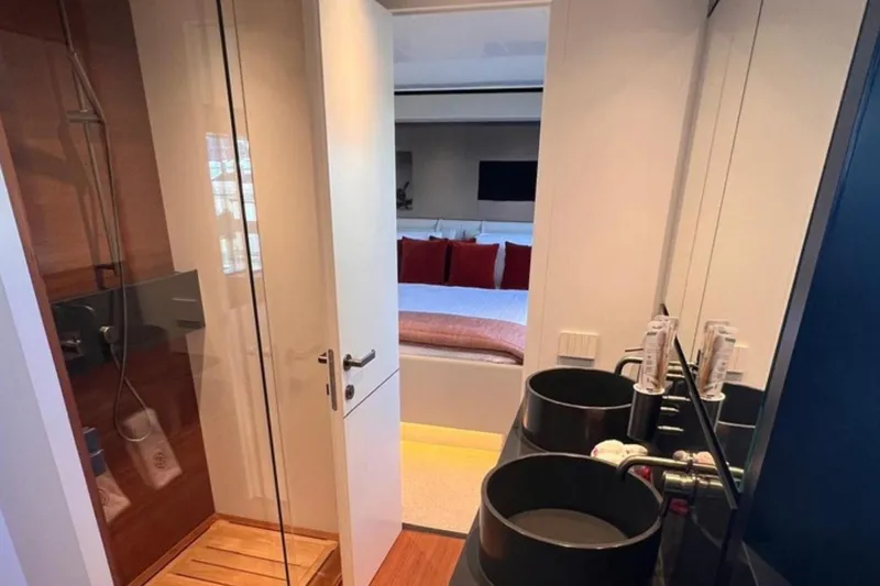  Yacht Photos Pics Luxurious Bluegame BGX 70 yacht interior featuring modern bathroom and cozy bedroom, 2020 model.