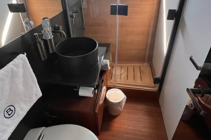  Yacht Photos Pics Luxurious bathroom in 2020 Bluegame BGX 70 yacht with modern fixtures and wooden accents.