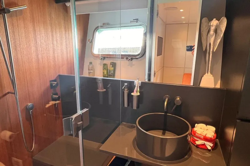  Yacht Photos Pics Luxurious bathroom interior of 2020 Bluegame BGX 70 yacht with modern fixtures and decor.