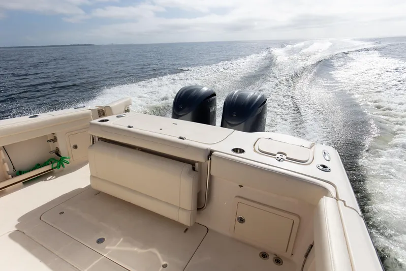 No Name Yacht Photos Pics 2022 Grady-White 326 CANYON boat cruising on open water, rear view.