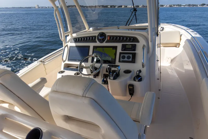 No Name Yacht Photos Pics 2022 Grady-White 326 CANYON boat cockpit with steering wheel and navigation controls.