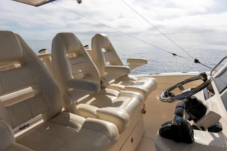 No Name Yacht Photos Pics Grady-White 326 CANYON 2022 boat interior with helm and seating, ocean view.