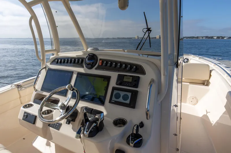 No Name Yacht Photos Pics 2022 Grady-White 326 CANYON boat dashboard with navigation controls on open water.