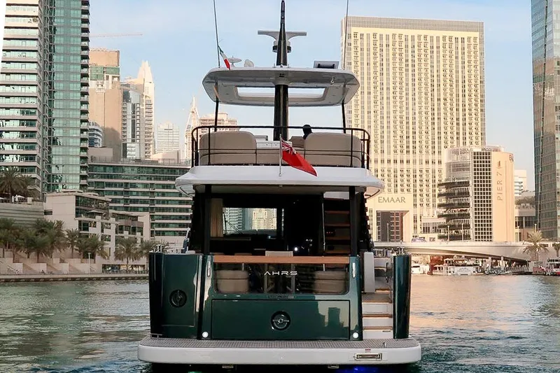 Azimut Magellano 60 Model 2025 Yacht Photos Pics 2025 Azimut Magellano 60 yacht in urban marina setting, skyscrapers in background.