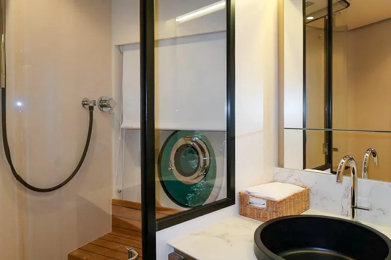 Azimut Magellano 60 Model 2025 Yacht Photos Pics Luxurious bathroom in 2025 Azimut Magellano 60 yacht with modern fixtures and porthole view.