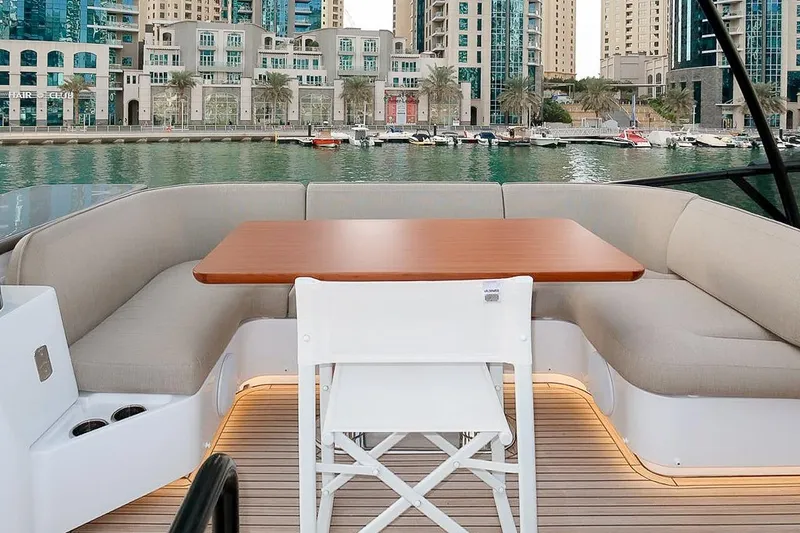 Azimut Magellano 60 Model 2025 Yacht Photos Pics Luxurious seating area on 2025 Azimut Magellano 60 yacht, docked in a modern marina.