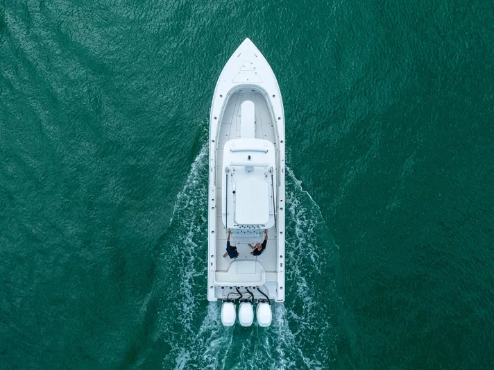  Yacht Photos Pics Aerial view of 2007 Fountain 34 Center Console boat cruising on open water.