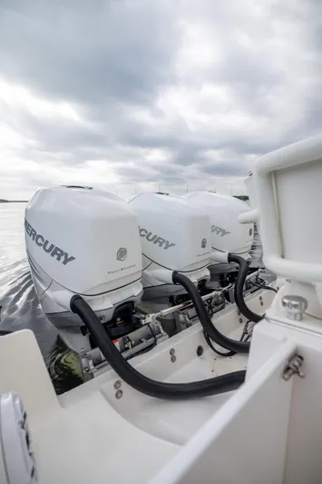  Yacht Photos Pics 2007 Fountain 34 Center Console with triple Mercury outboard engines on a cloudy day.