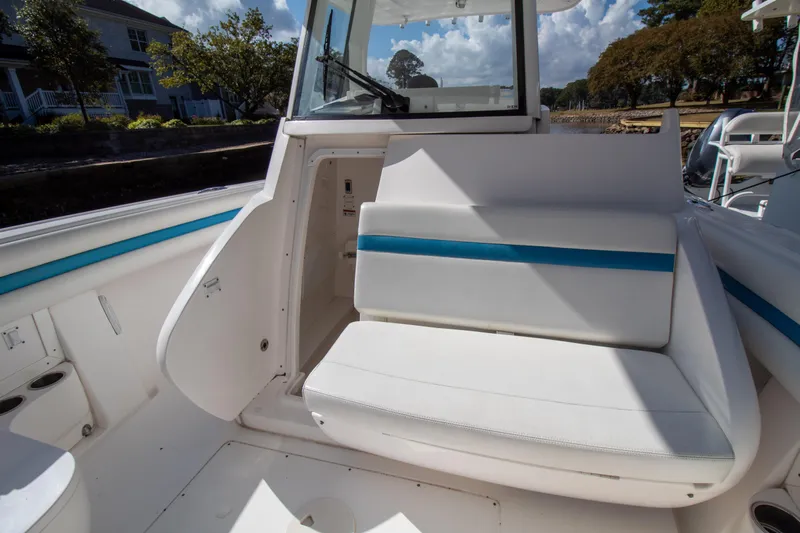Ami Kids Donation Yacht Photos Pics 2015 Intrepid 327 Center Console boat interior with white seating and blue accents.