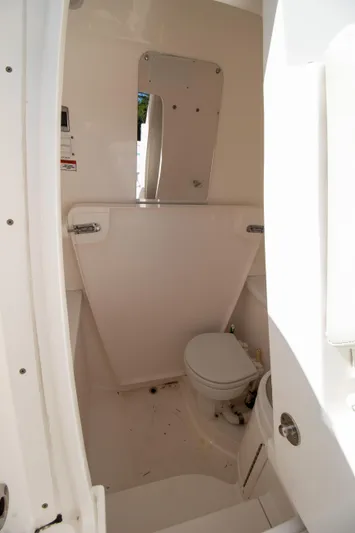 Ami Kids Donation Yacht Photos Pics 2015 Intrepid 327 Center Console boat bathroom interior with toilet and mirror.