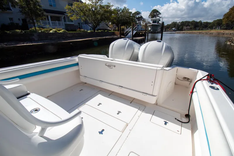 Ami Kids Donation Yacht Photos Pics 2015 Intrepid 327 Center Console boat with dual engines on a calm waterway.