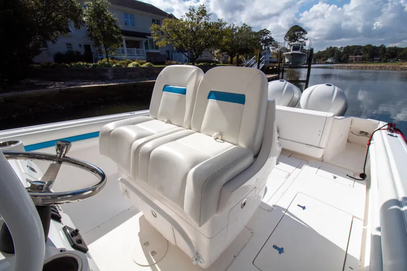 Ami Kids Donation Yacht Photos Pics 2015 Intrepid 327 Center Console boat with dual seats and steering wheel.