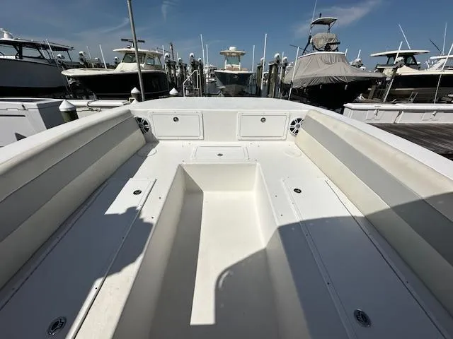  Yacht Photos Pics 2021 AmeraCat 27 Gen II DC boat interior at marina, showcasing spacious seating and storage.