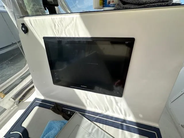  Yacht Photos Pics 2021 AmeraCat 27 Gen II DC interior with mounted screen and seating area.