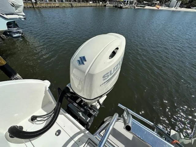 Yacht Photos Pics 2021 AmeraCat 27 Gen II DC with Suzuki outboard motor on a calm waterway.