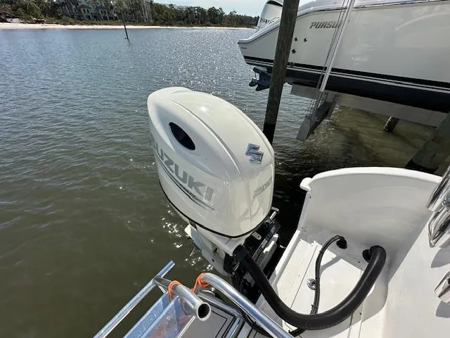  Yacht Photos Pics 2021 AmeraCat 27 Gen II DC with Suzuki outboard motor docked by the water.
