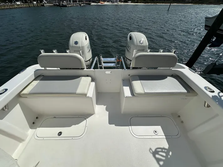  Yacht Photos Pics 2021 AmeraCat 27 Gen II DC boat with dual outboard engines on a calm waterway.