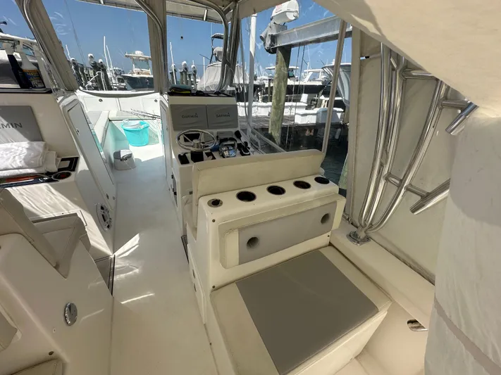 Yacht Photos Pics 2021 AmeraCat 27 Gen II DC boat interior with seating and helm, docked at marina.