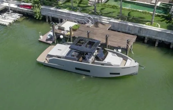  Yacht Photos Pics 2022 De Antonio Yachts D42 docked in a serene waterfront setting.