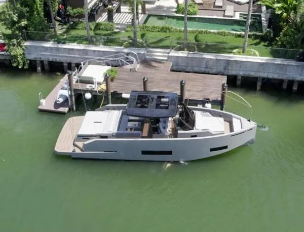  Yacht Photos Pics 2022 De Antonio Yachts D42 docked in a serene waterfront setting.