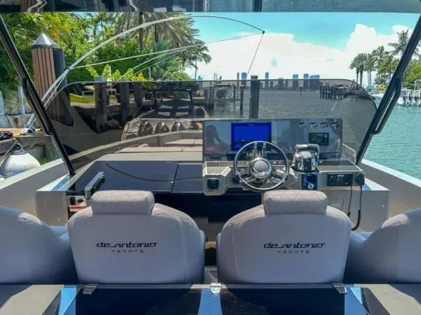  Yacht Photos Pics Cockpit view of 2022 De Antonio Yachts D42, featuring modern controls and waterfront backdrop.