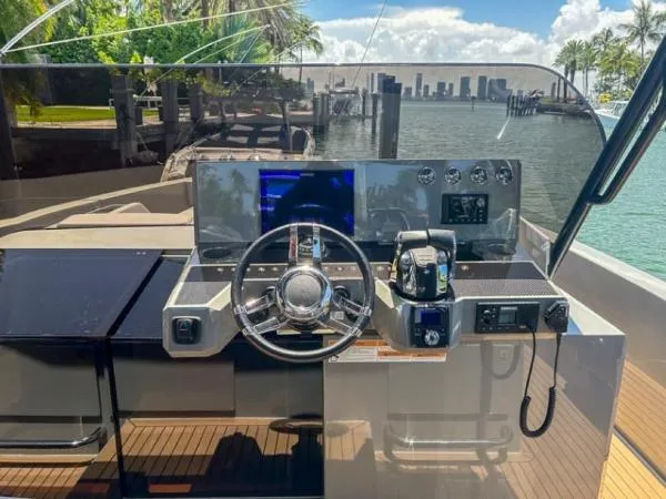  Yacht Photos Pics 2022 De Antonio Yachts D42 helm with city skyline and waterfront view.