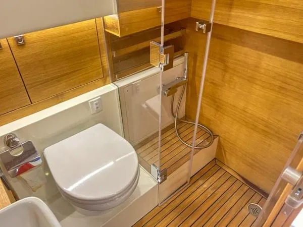  Yacht Photos Pics Luxurious bathroom in 2022 De Antonio Yachts D42, featuring wood accents and modern fixtures.
