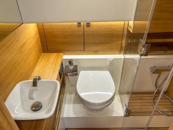  Yacht Photos Pics Luxurious bathroom in 2022 De Antonio Yachts D42, featuring modern sink and toilet.