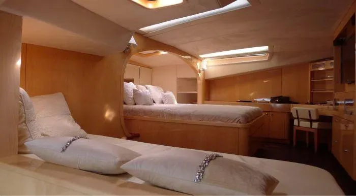 Cattitude Yacht Photos Pics Luxurious interior of 2013 Privilege 745 yacht with elegant bedding and wooden furnishings.