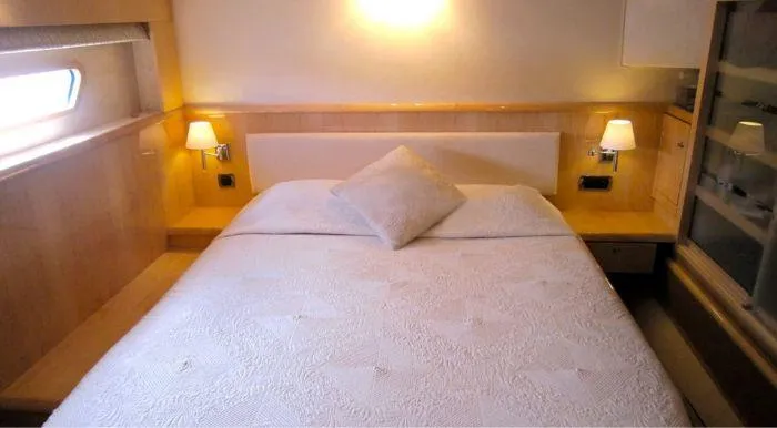 Cattitude Yacht Photos Pics Luxurious bedroom interior of 2013 Privilege 745 yacht with cozy lighting and elegant bedding.