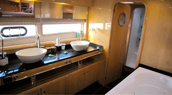 Cattitude Yacht Photos Pics Luxurious bathroom interior of 2013 Privilege 745 yacht with dual sinks and modern design.