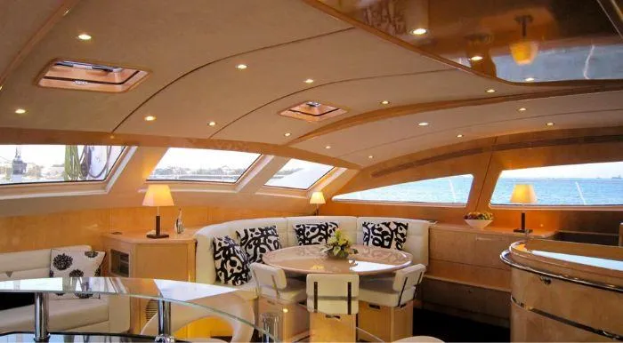 Cattitude Yacht Photos Pics Luxurious interior of 2013 Privilege 745 yacht with elegant seating and panoramic windows.