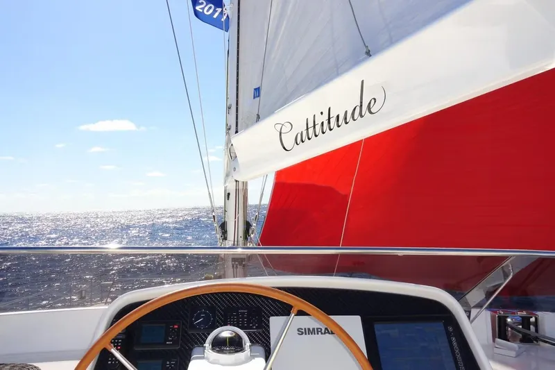 Cattitude Yacht Photos Pics Sailing on Privilege 745 yacht "Cattitude" with red sail, ocean view, sunny day.