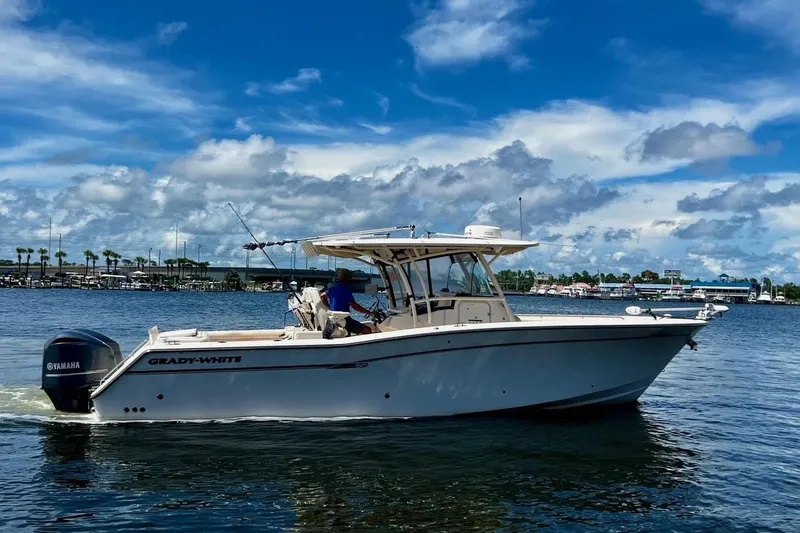  Yacht Photos Pics 2015 Grady-White Canyon 336 boat cruising on a sunny day with Yamaha engines.