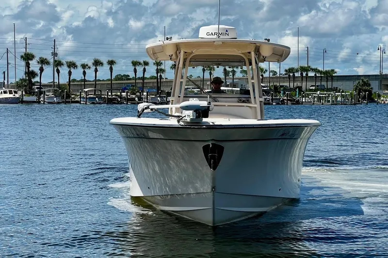  Yacht Photos Pics 2015 Grady-White Canyon 336 boat on water, clear sky, palm trees in background.