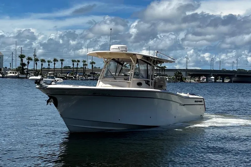  Yacht Photos Pics 2015 Grady-White Canyon 336 boat cruising on a sunny day near a bridge.